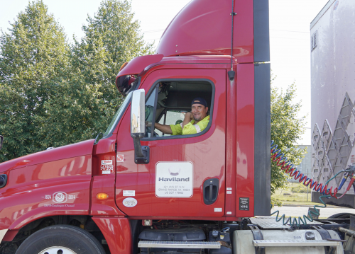 Red Haviland semi truck with driver