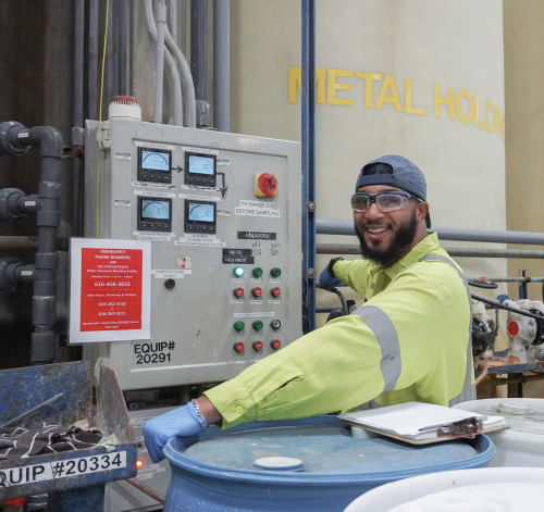 Employee smiling while working with product